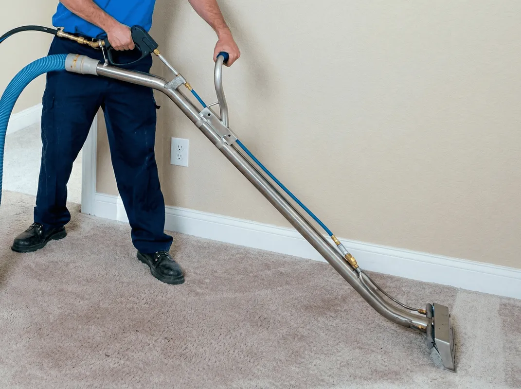 Professional operating a liquid removal machine on a carpeted floor in Colorado Springs, CO